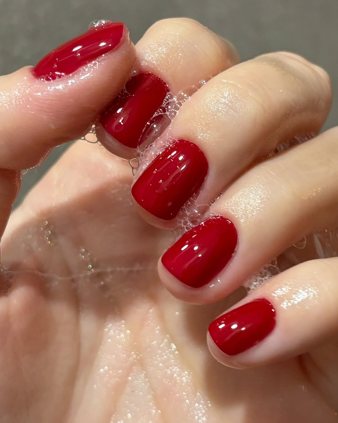 Glossy red nails create playful elegance