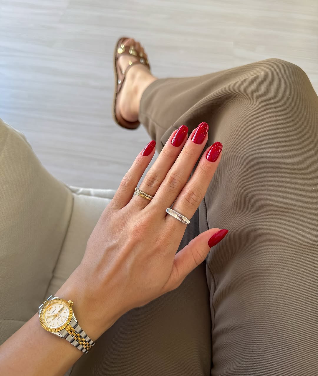 Stylish red nails complement a chic outfit
