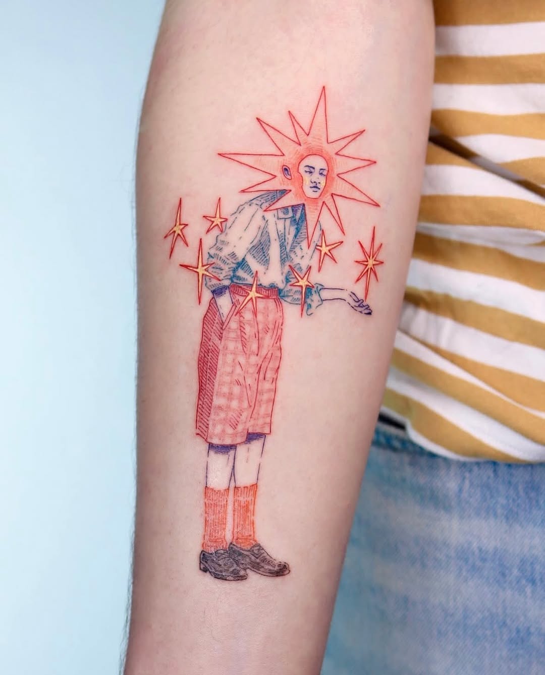 Whimsical character tattoo with vibrant star details