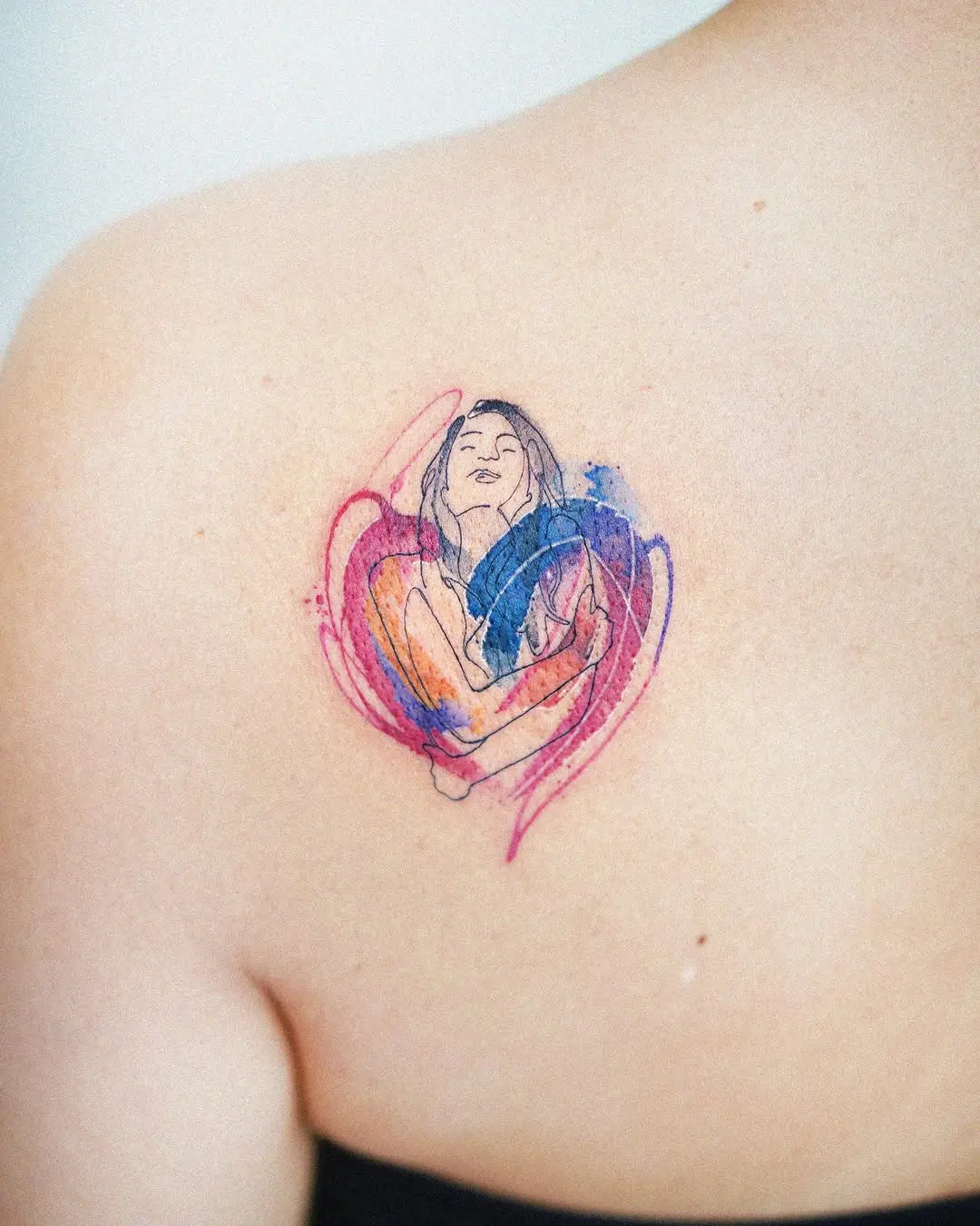 Vibrant watercolor woman tattoo on back