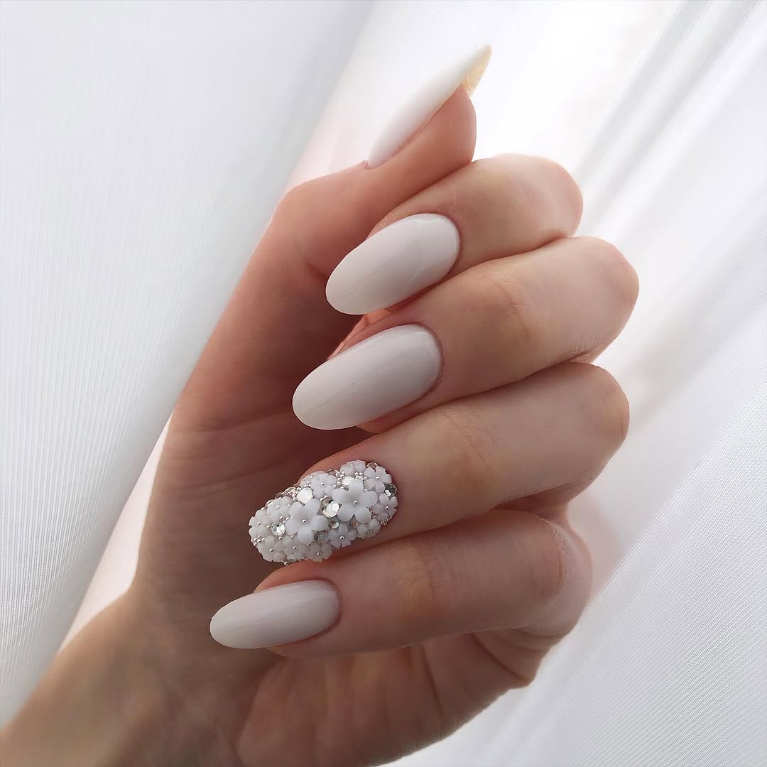 Elegant white nails with stunning studded design