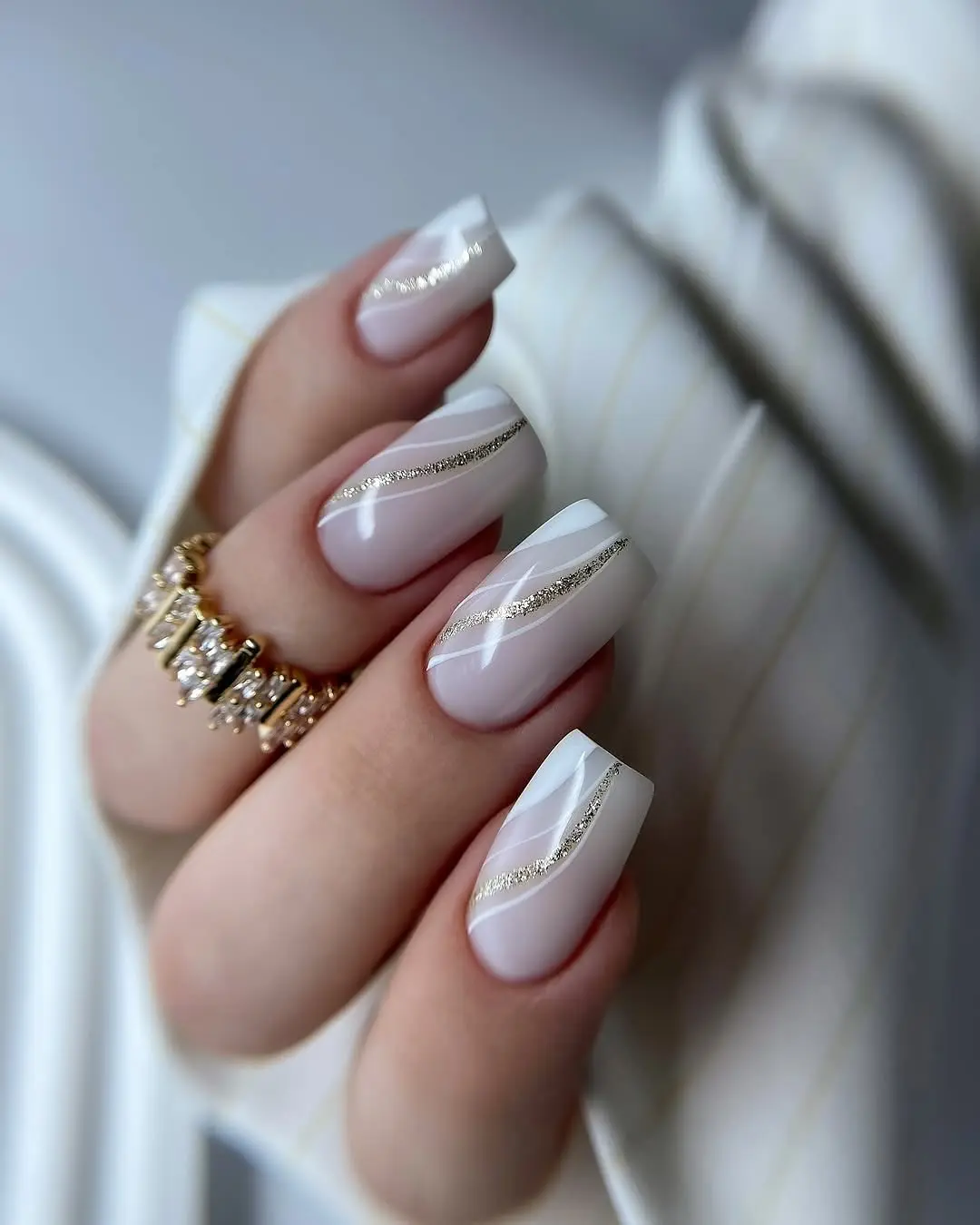 Elegant white nails with a touch of gold
