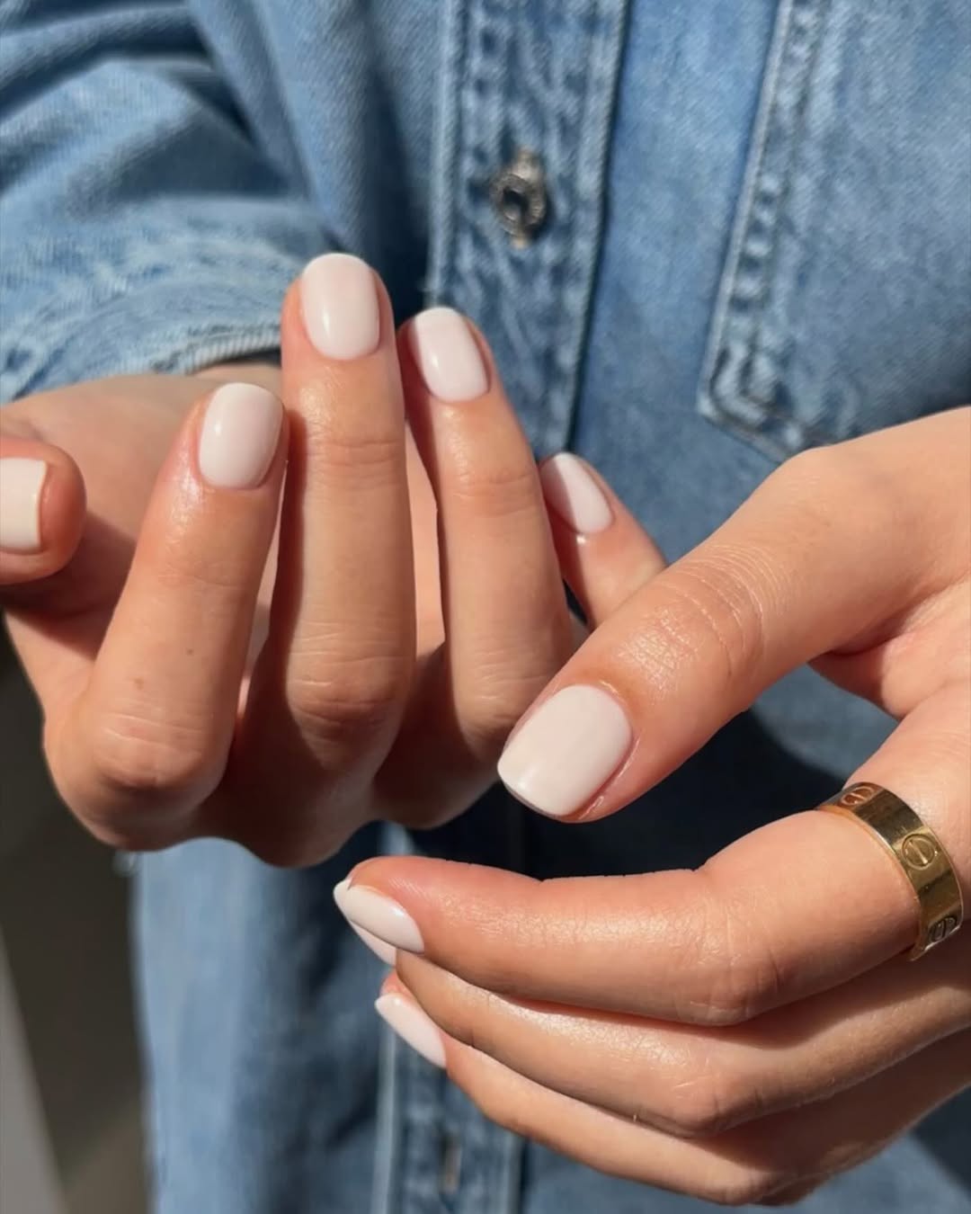 Chic and minimalist white nail look displayed.