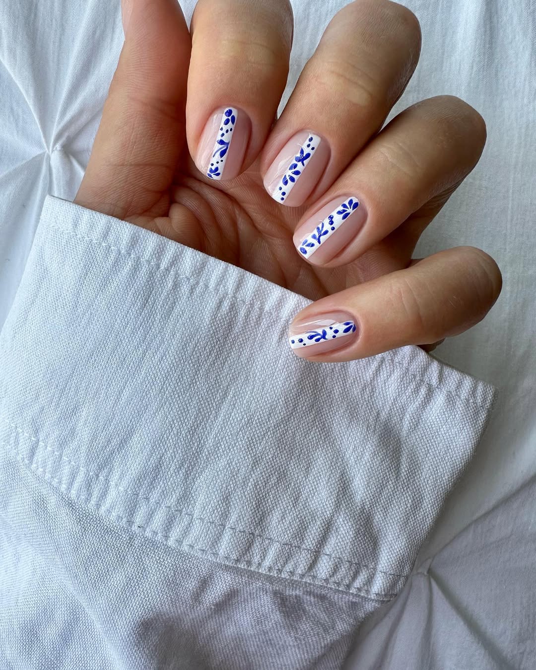 Chic white nails with blue floral accents