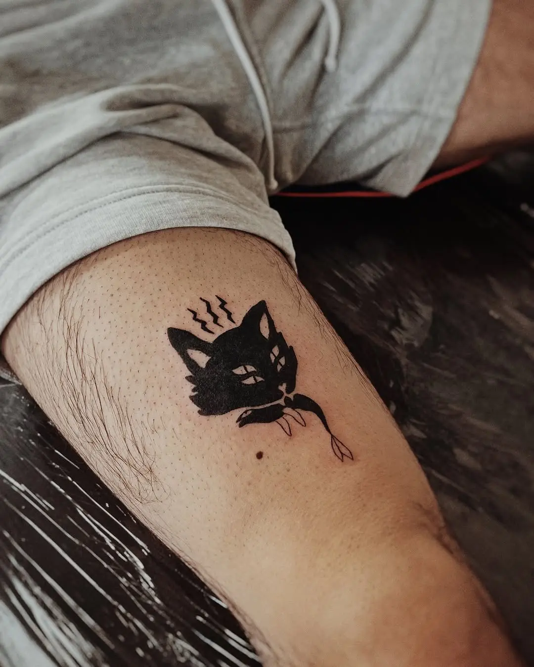 Chic cat tattoo with mystical vibes