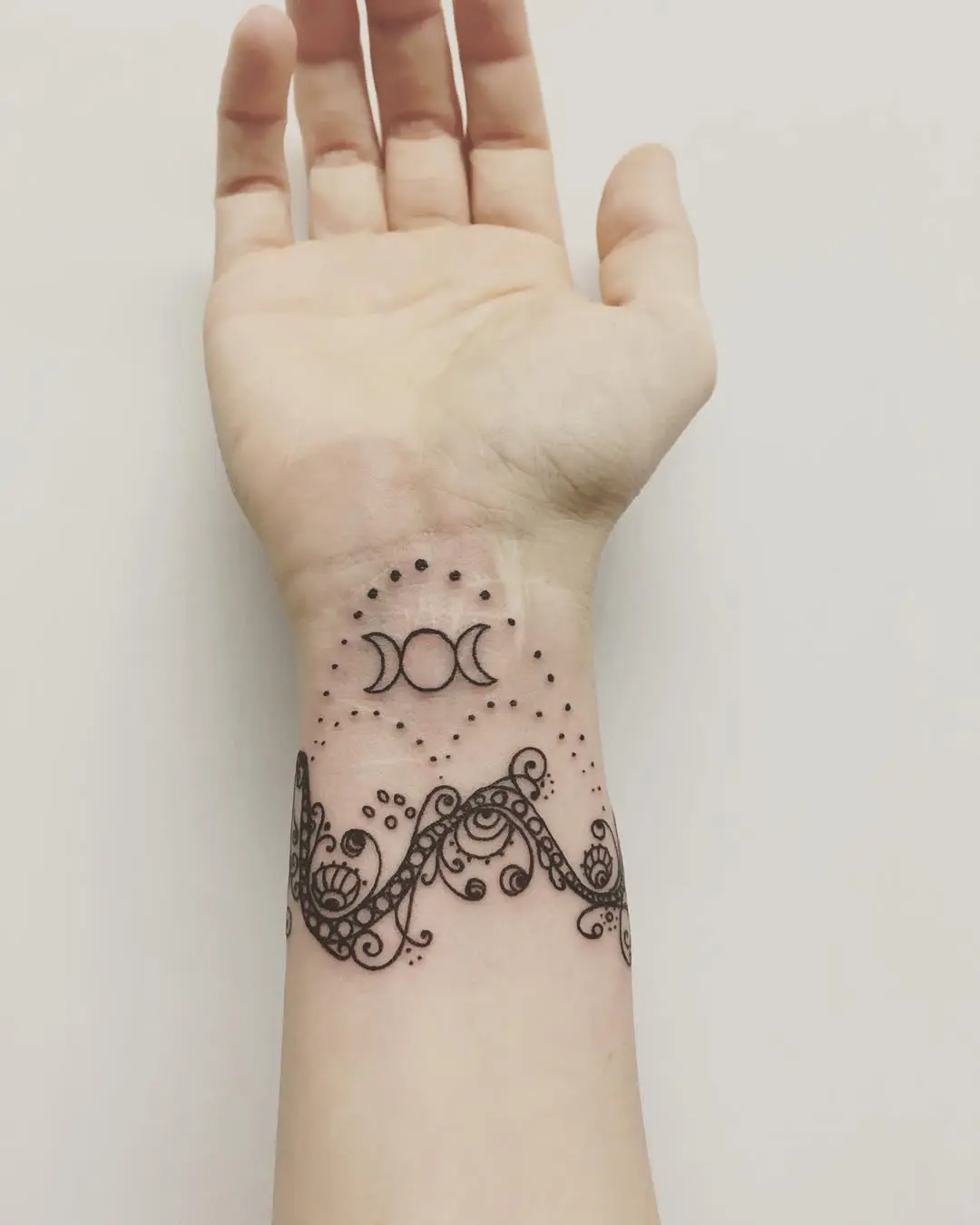 Intricate Moon and Floral Tattoo Design