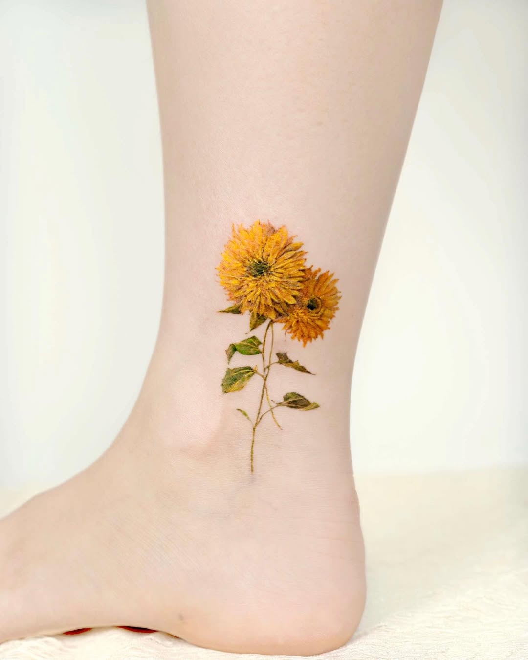 Delicate floral leg tattoo with vibrant colors