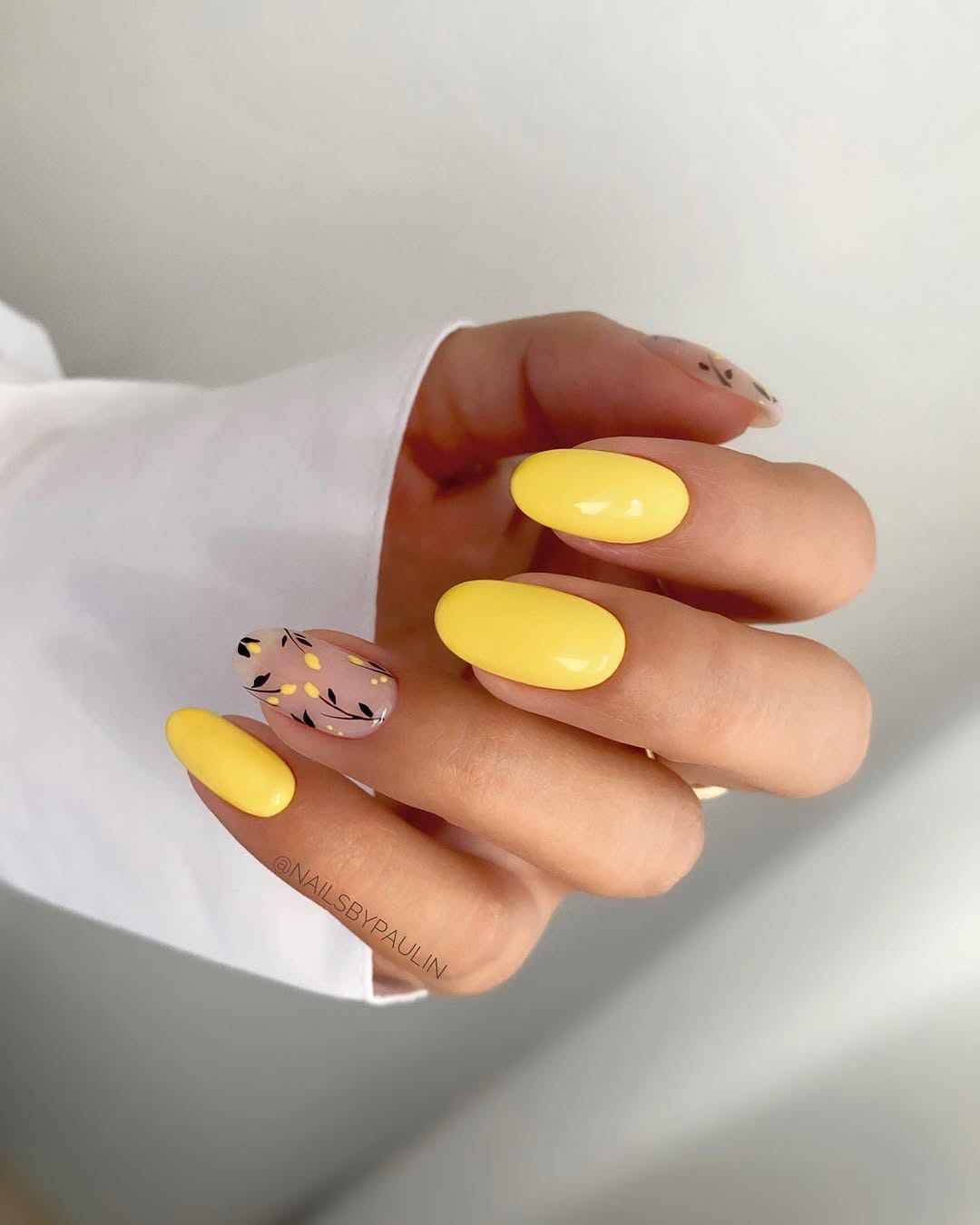 Chic yellow nails with stylish accent design