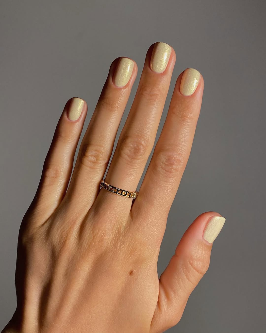 Glistening yellow nails shine elegantly