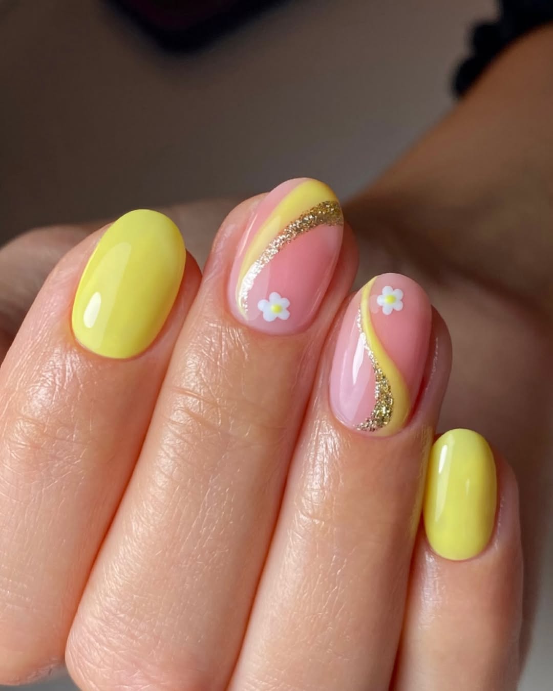 Vibrant yellow nails with floral accents