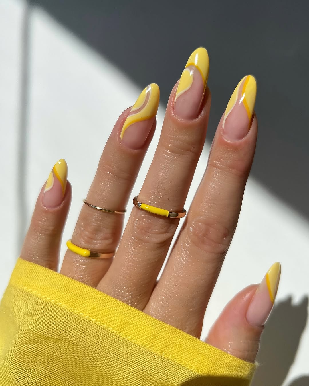 Vibrant yellow nails with artistic designs