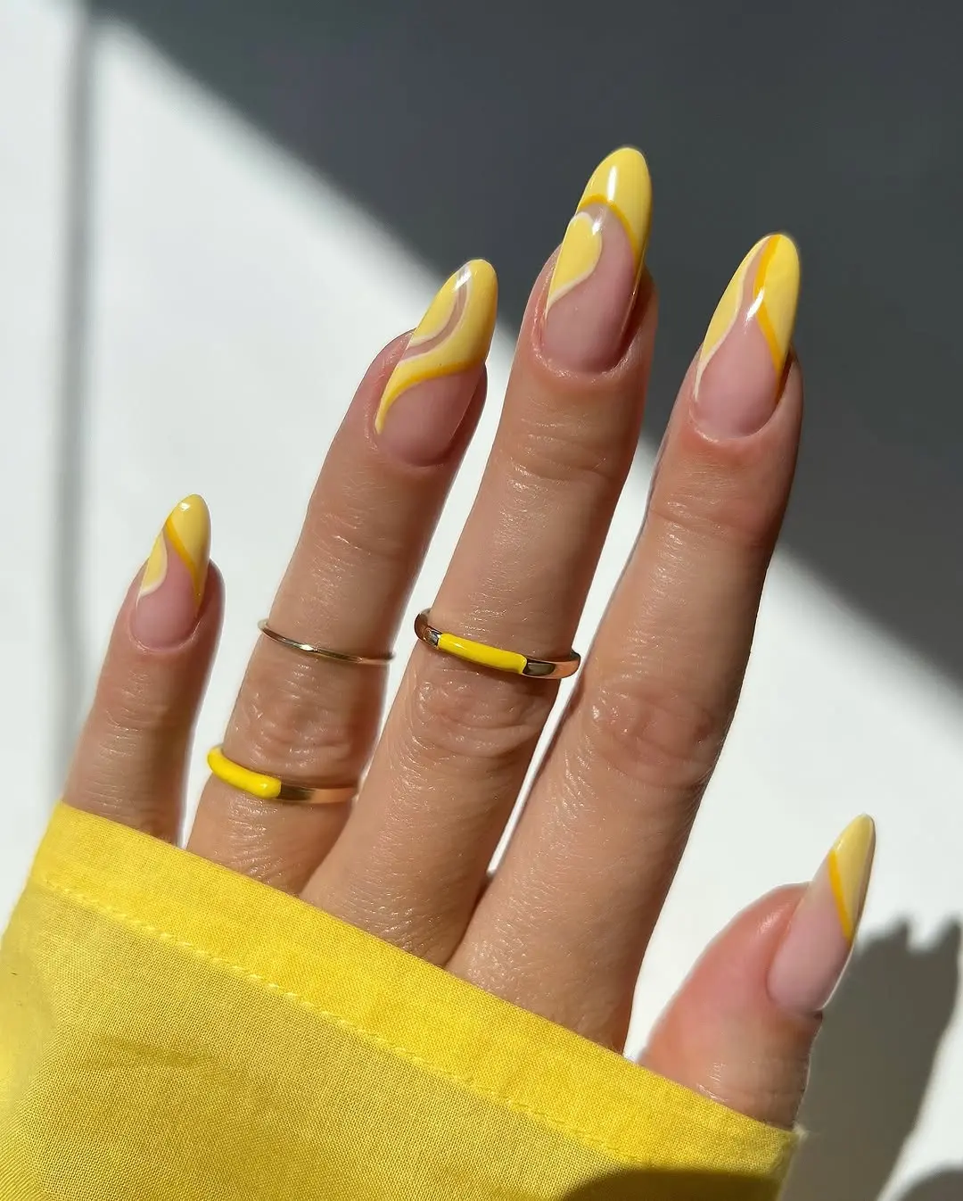 Vibrant yellow nails with artistic designs