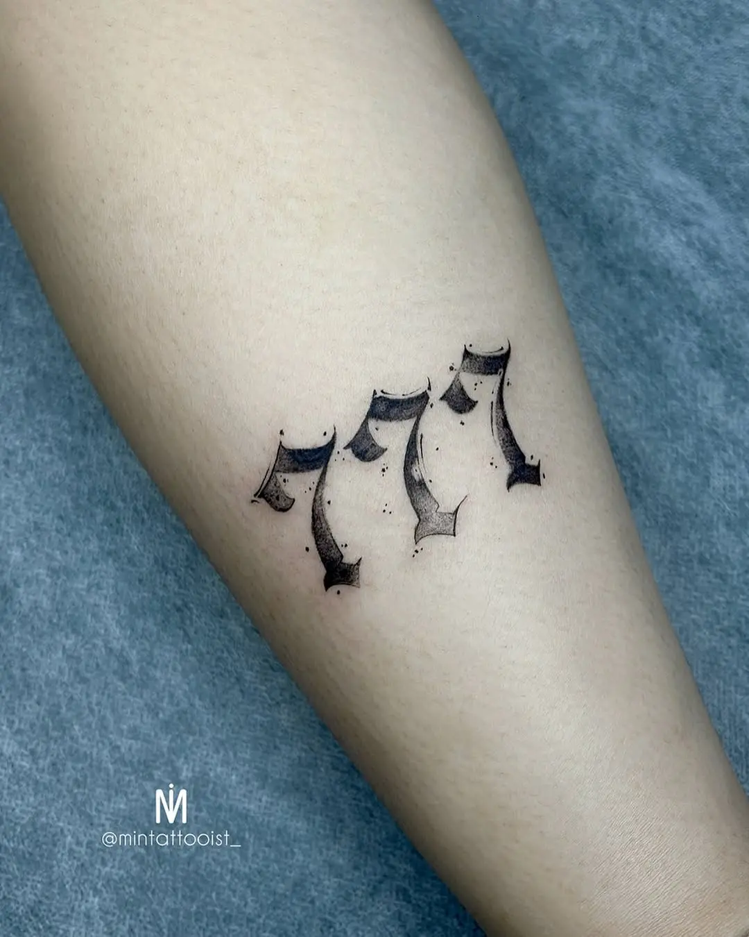 Stylish 777 tattoo with intricate design elements
