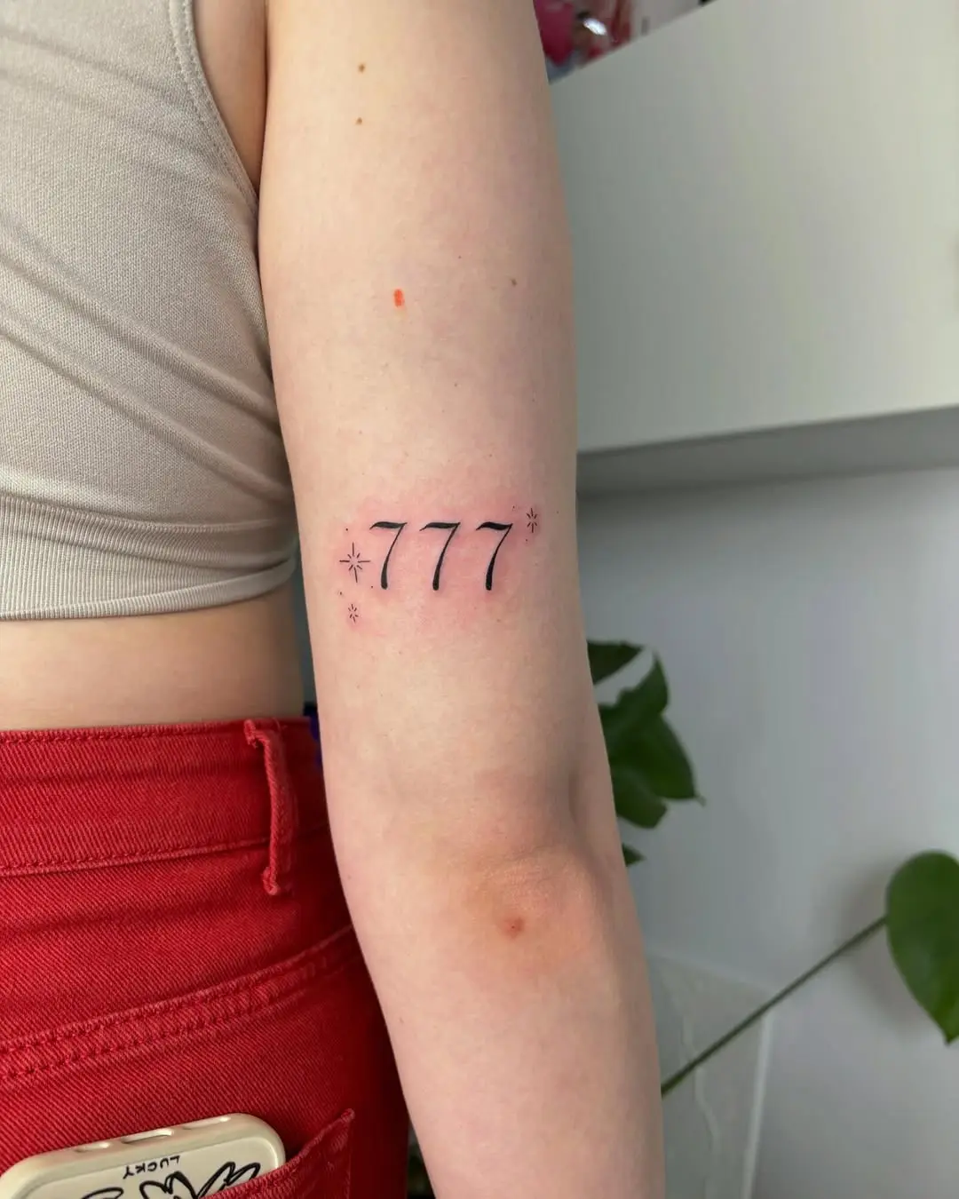 Captivating 777 Tattoo with Star Accents
