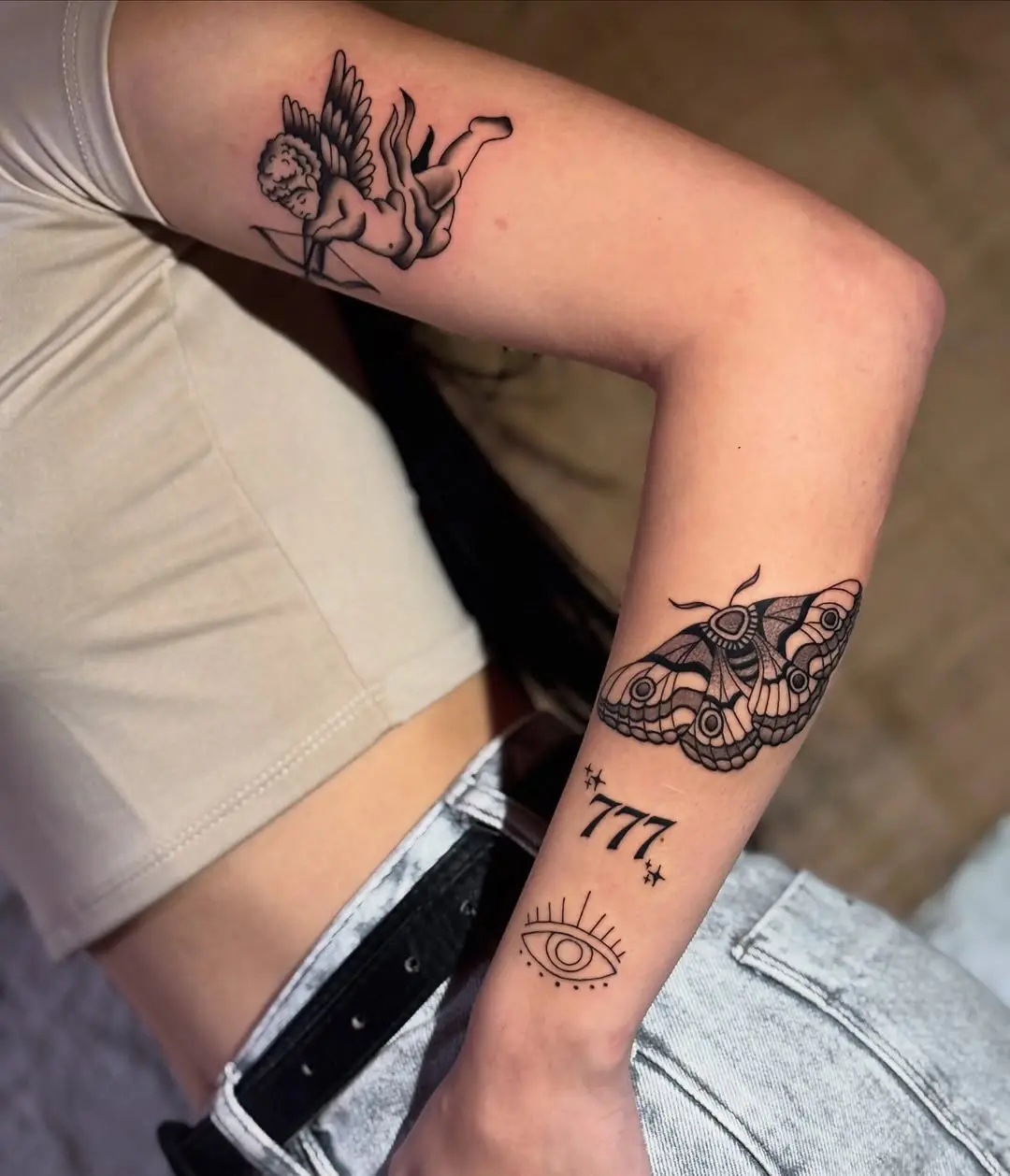 Elegant 777 tattoo with symbolic imagery