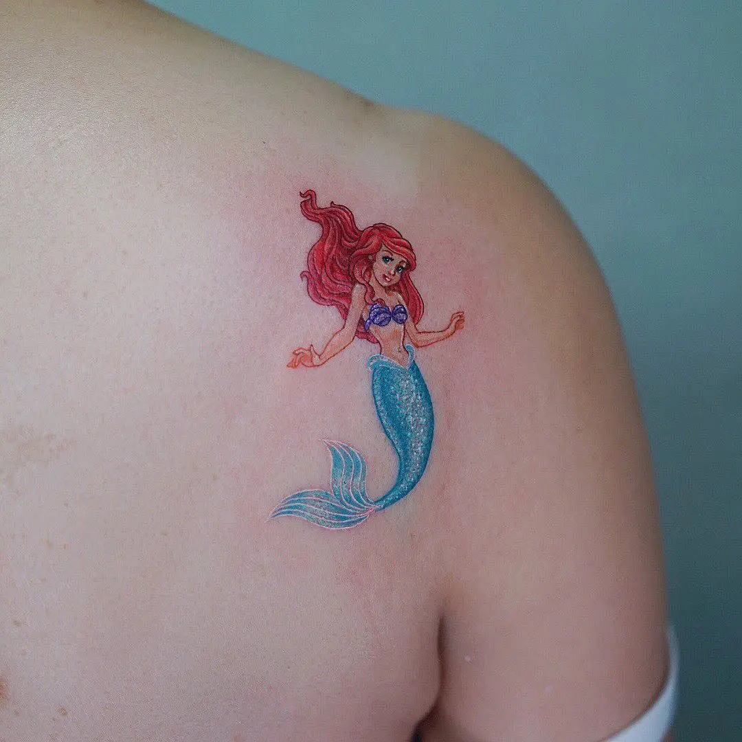 Vibrant tattoo inspired by Ariel the mermaid