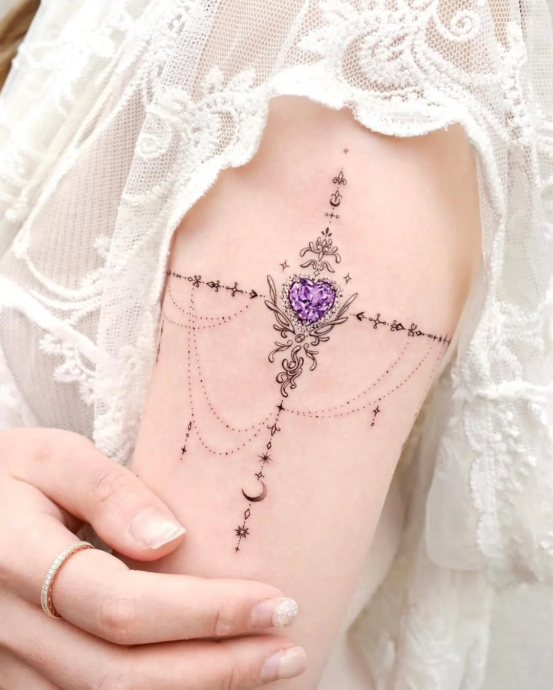 Elegant lace arm tattoo with gemstone heart