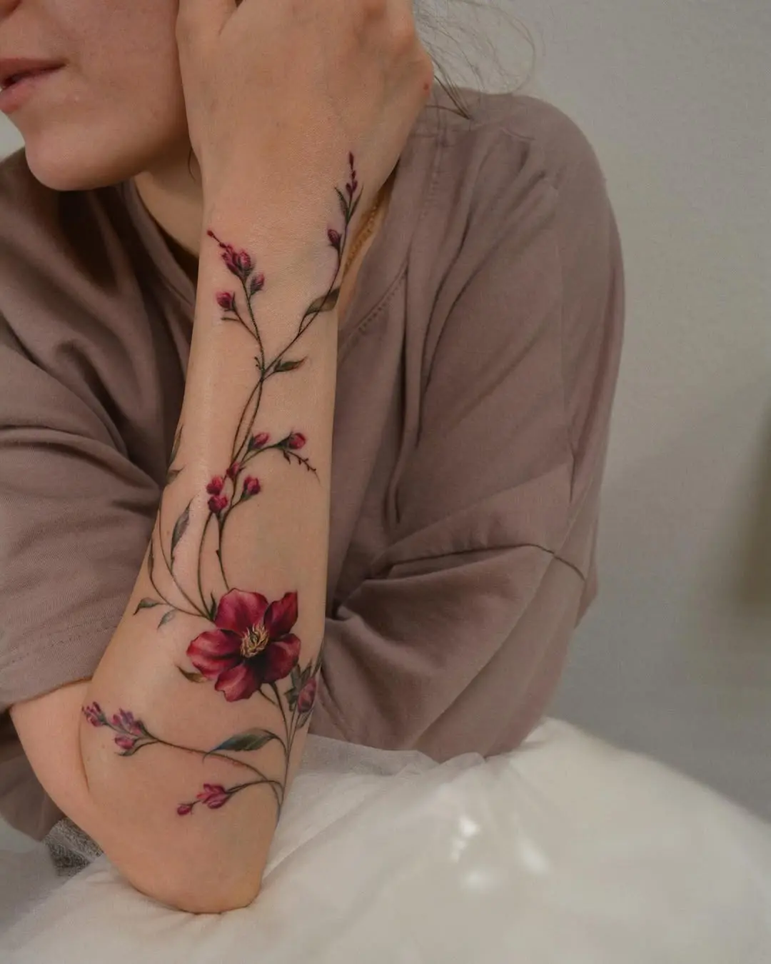 Elegant floral arm tattoo design for women