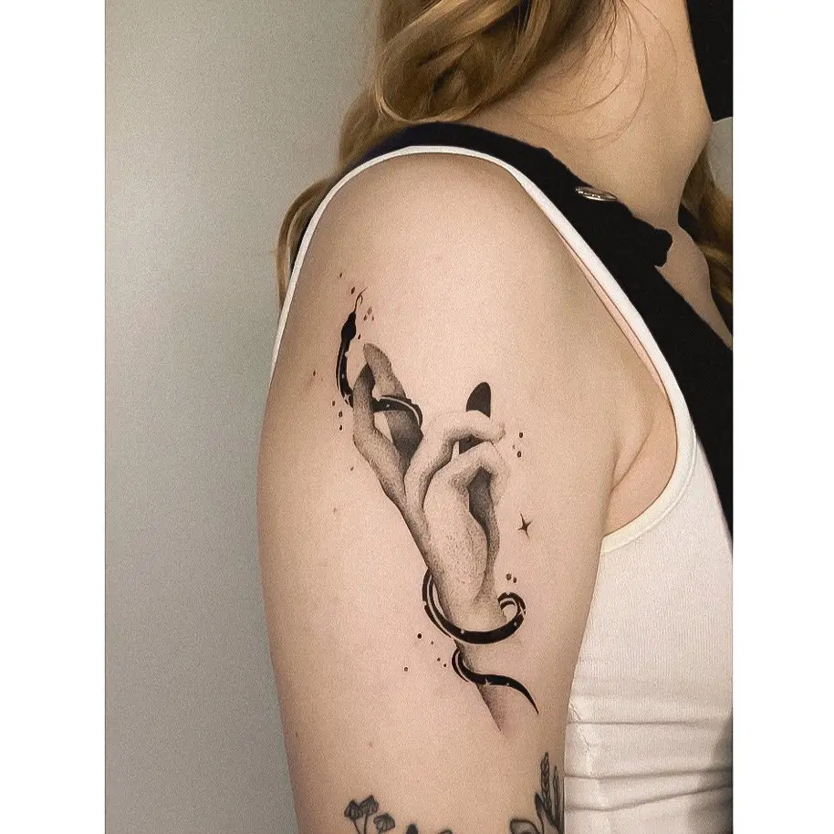 Elegant hand tattoo with flowing ribbon design