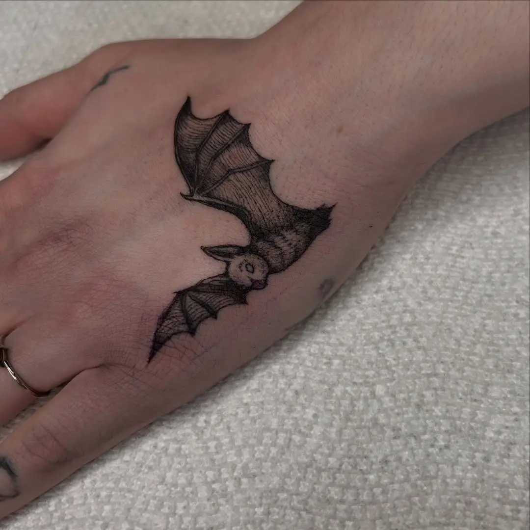 Realistic bat tattoo on hand showcases artistry