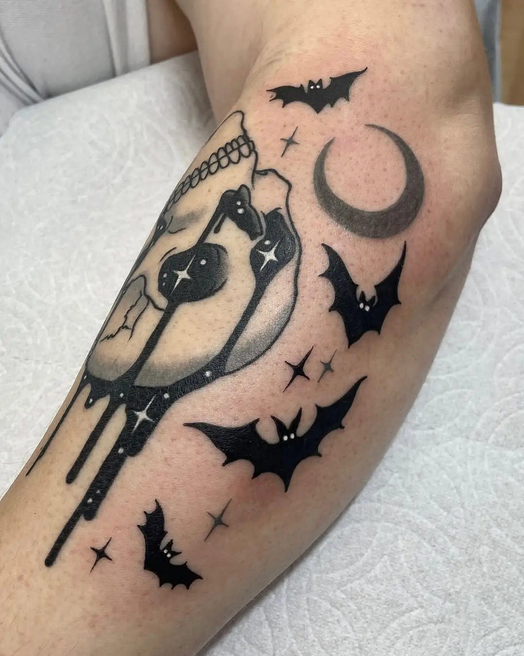 Chic bat tattoo with skull and moon motifs