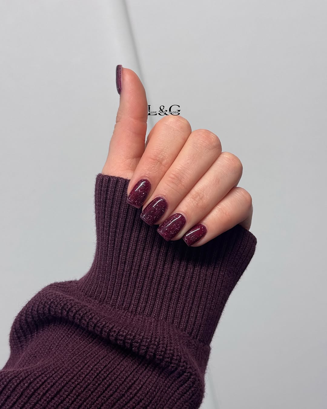 Elegant burgundy nails with stunning glitter accents