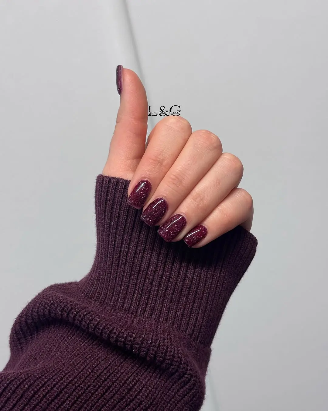 Elegant burgundy nails with stunning glitter accents