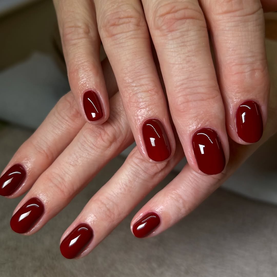 Elegant burgundy nails radiate classic charm