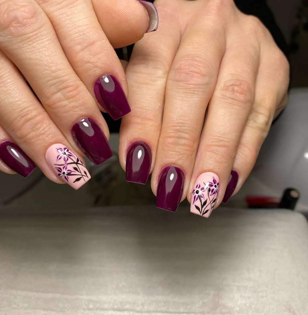 Chic burgundy nails with floral accents