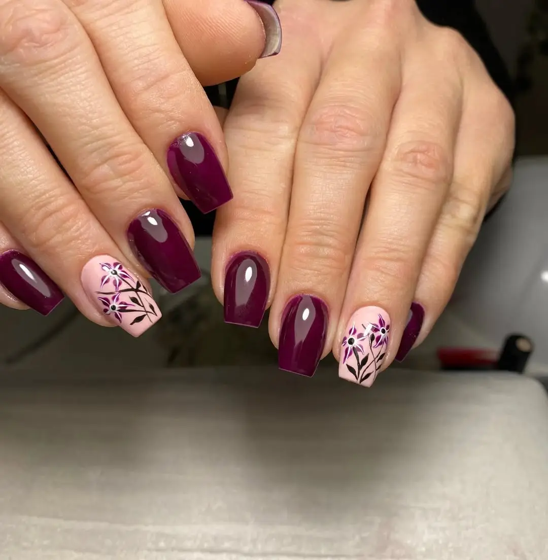 Chic burgundy nails with floral accents