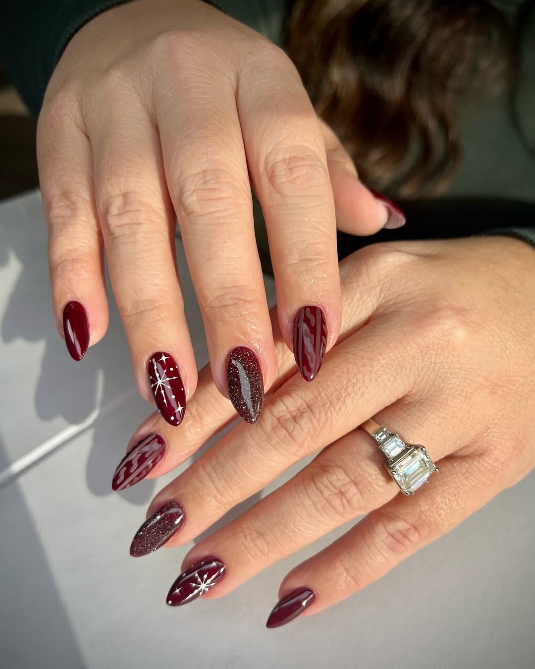 Elegant burgundy nails with sparkly accents