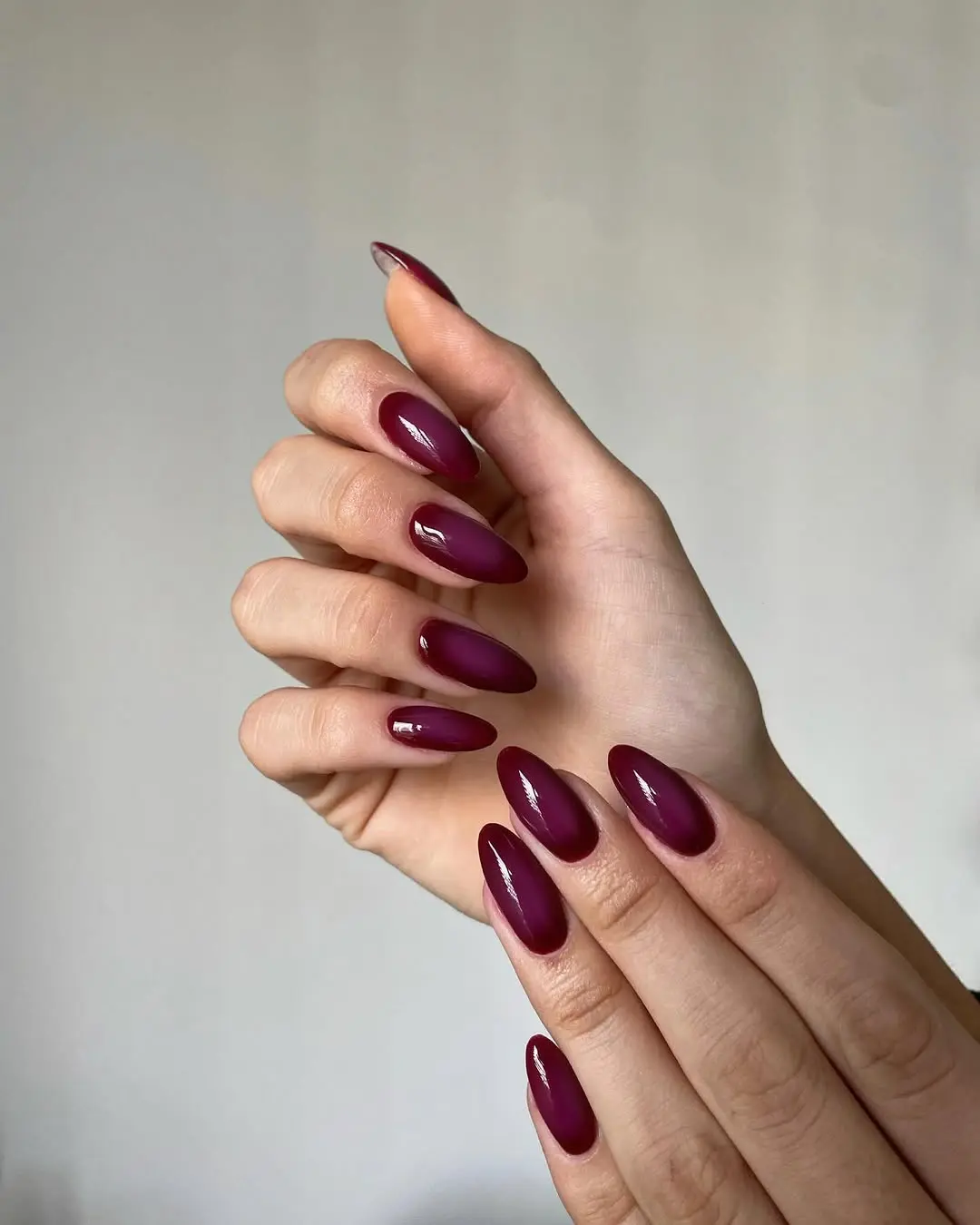 Elegant glossy burgundy oval-shaped nails