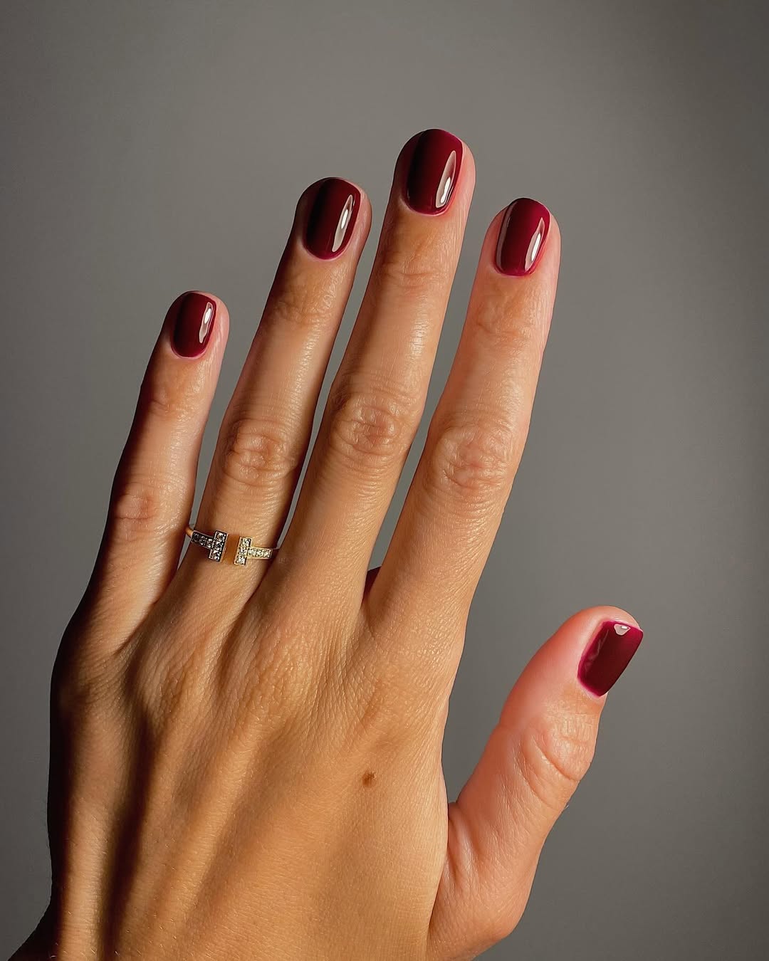 Stylish gloss on chic burgundy nails
