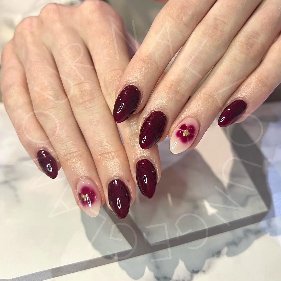 Elegant burgundy nails with floral accents