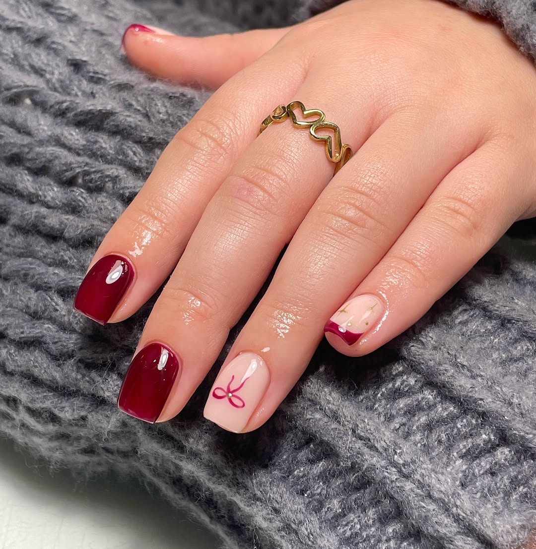 Chic burgundy nails with playful design accents