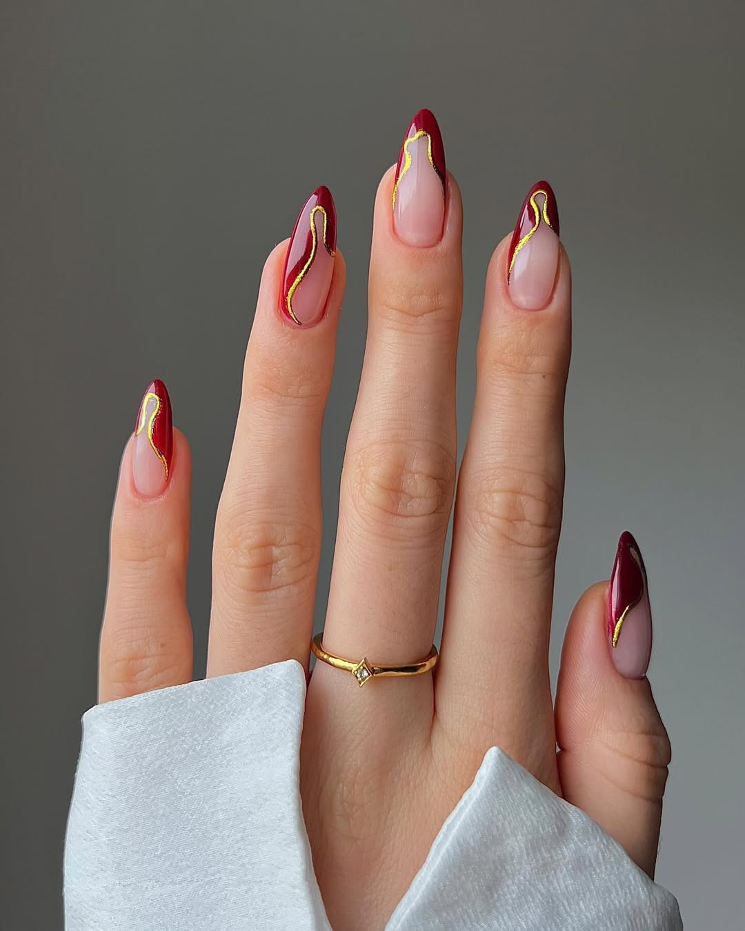 Elegant Burgundy Nails with Glamorous Gold Accents
