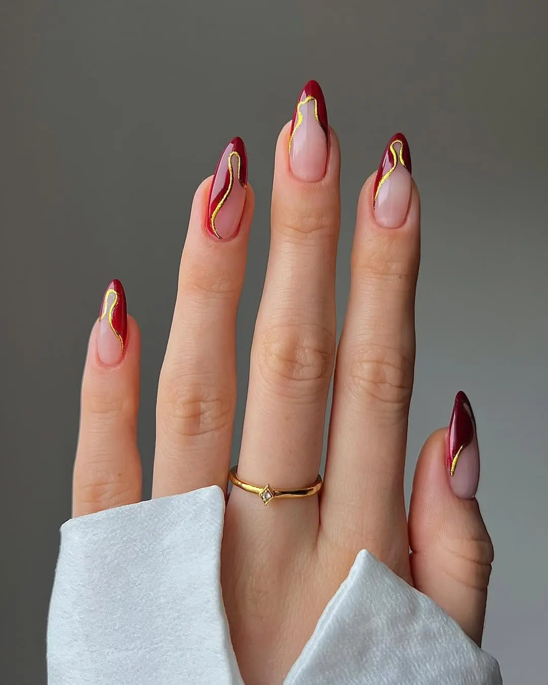 Elegant Burgundy Nails with Glamorous Gold Accents