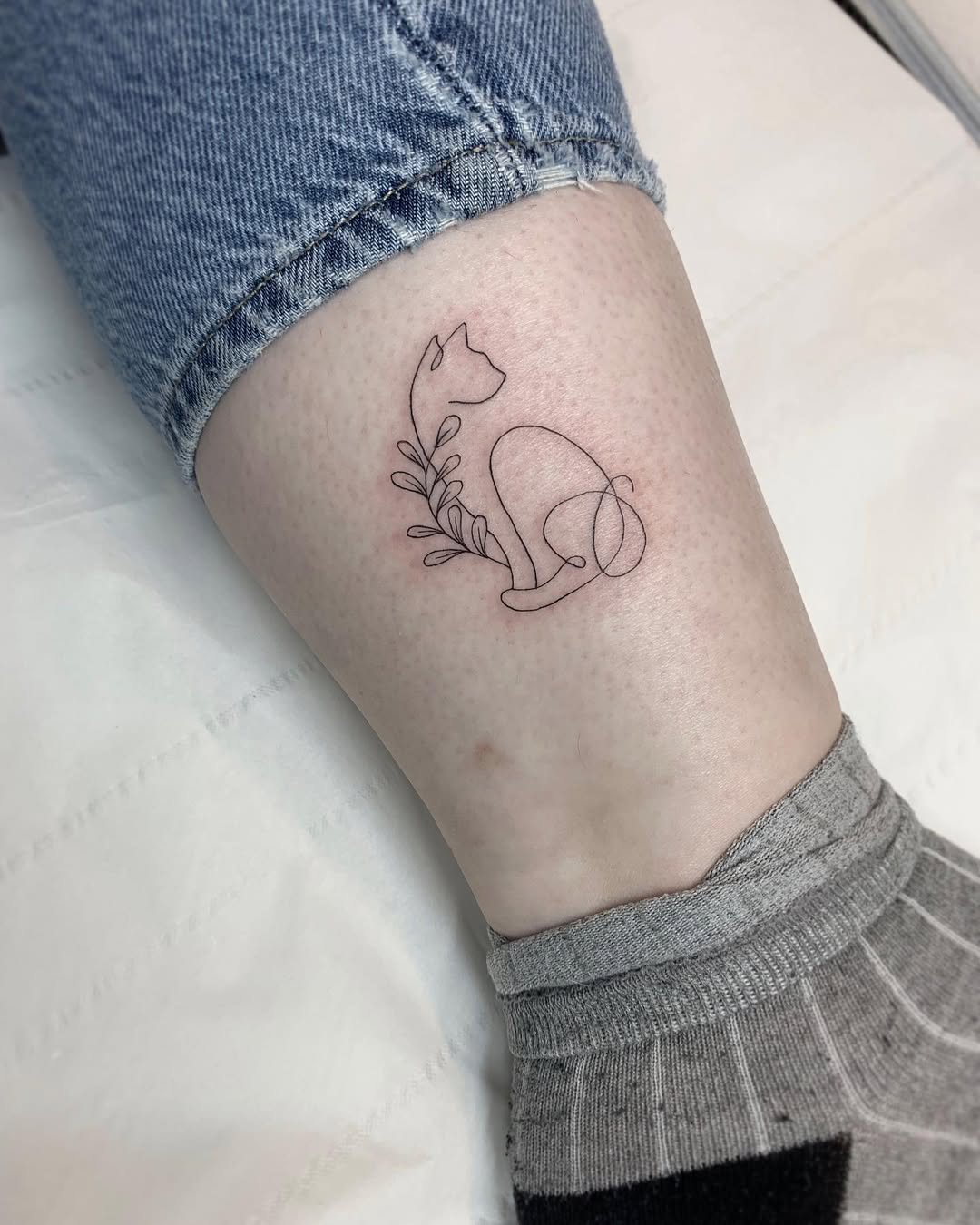 Charming minimalist cat outline with foliage