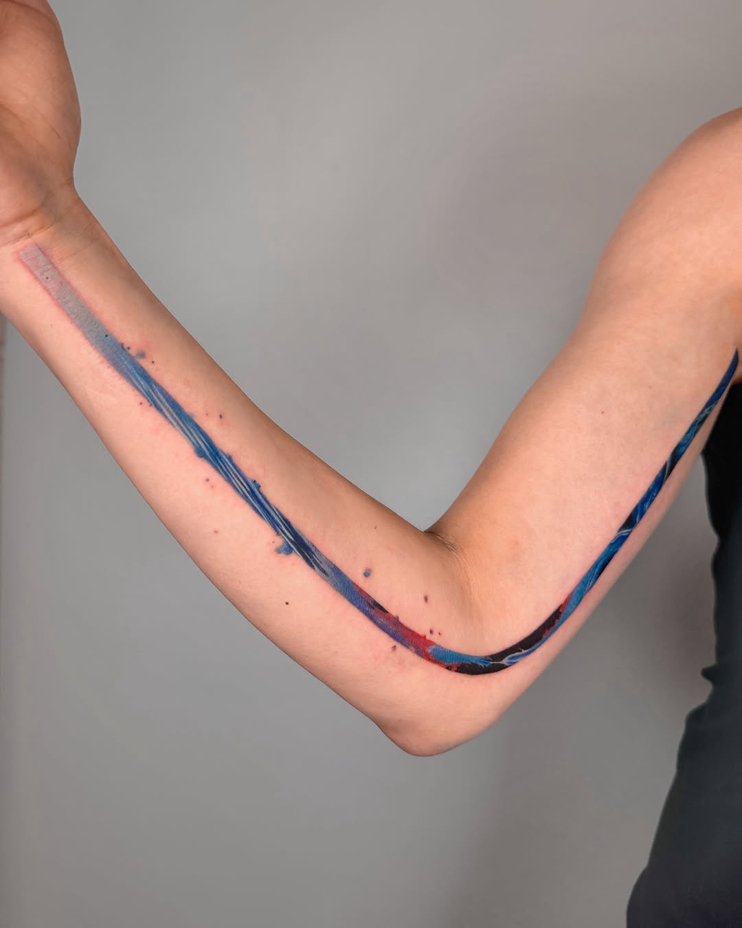 Unique colorful flowing arm tattoo design