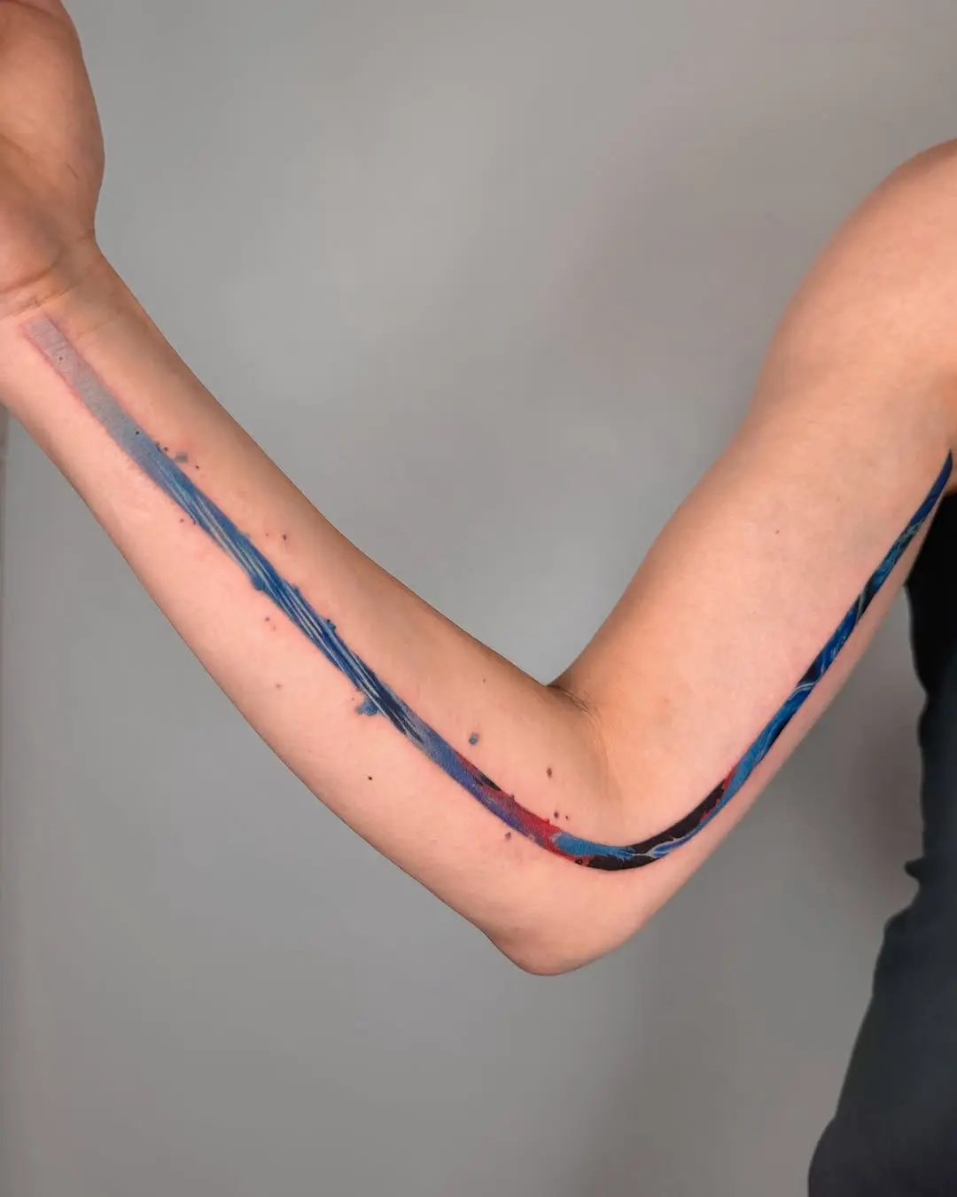 Unique colorful flowing arm tattoo design