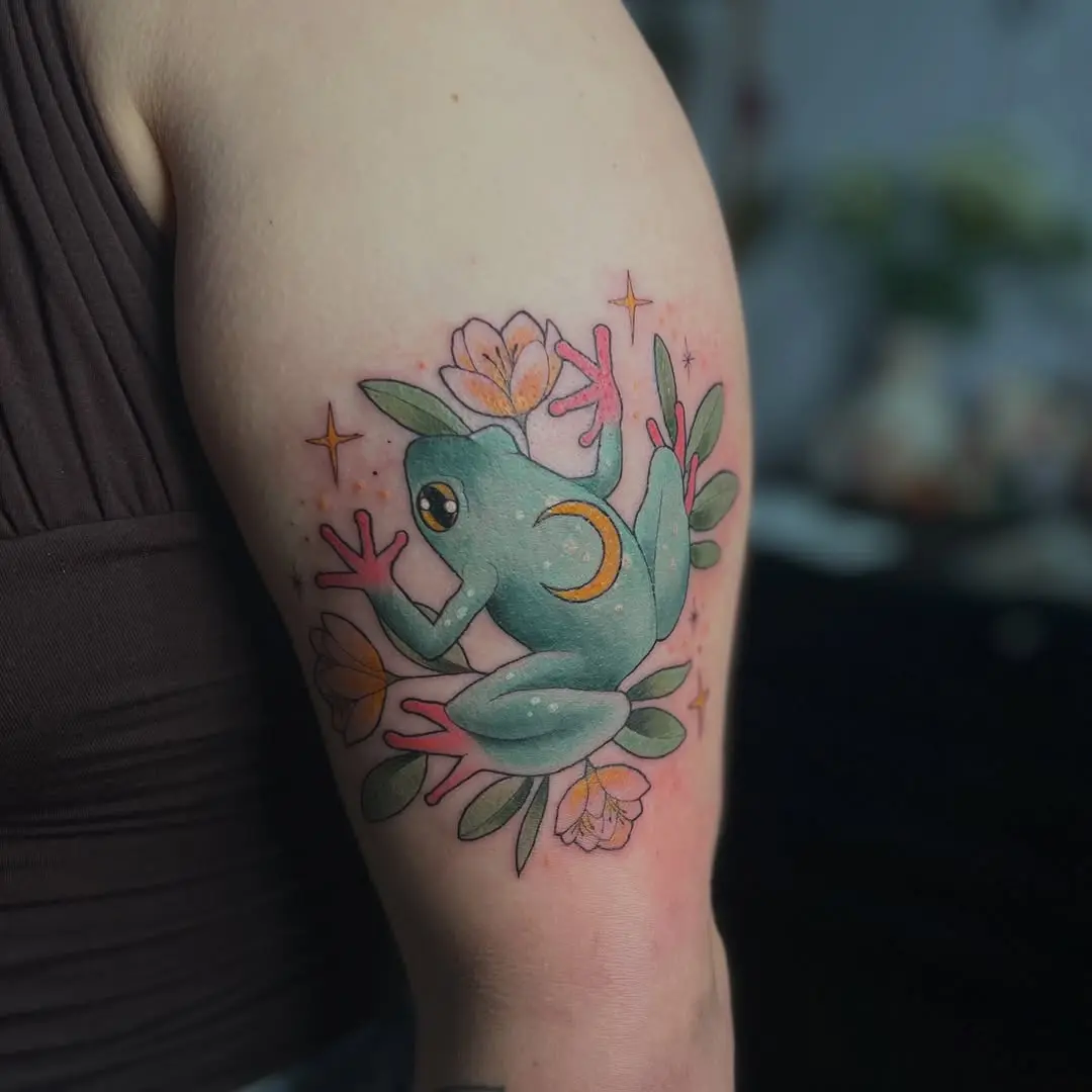 Whimsical frog tattoo with floral accents