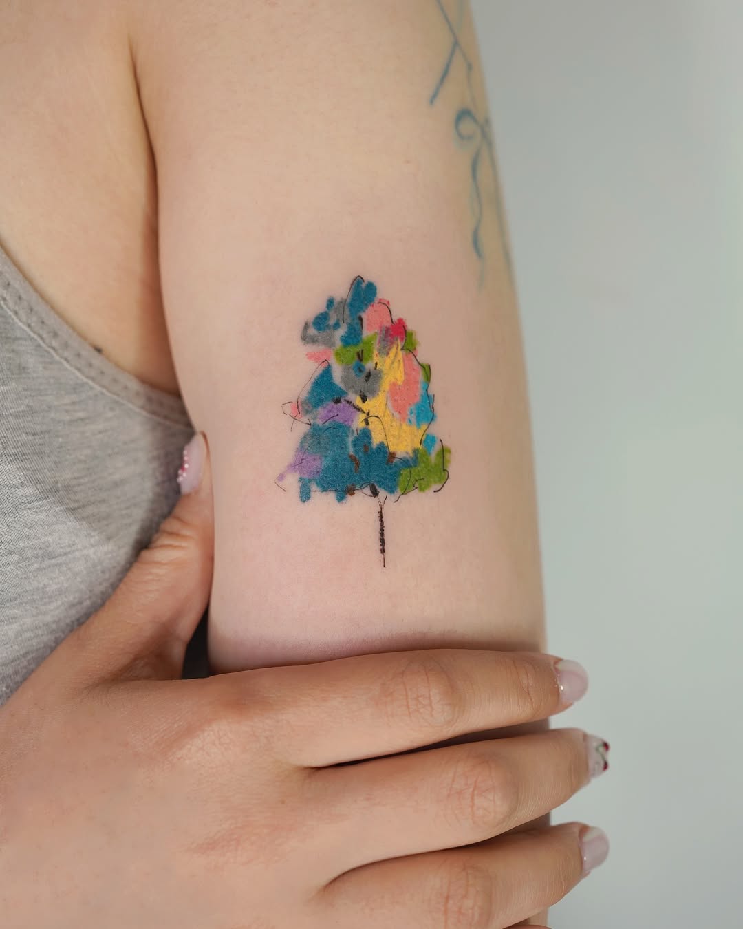 A colorful, artistic tree tattoo design