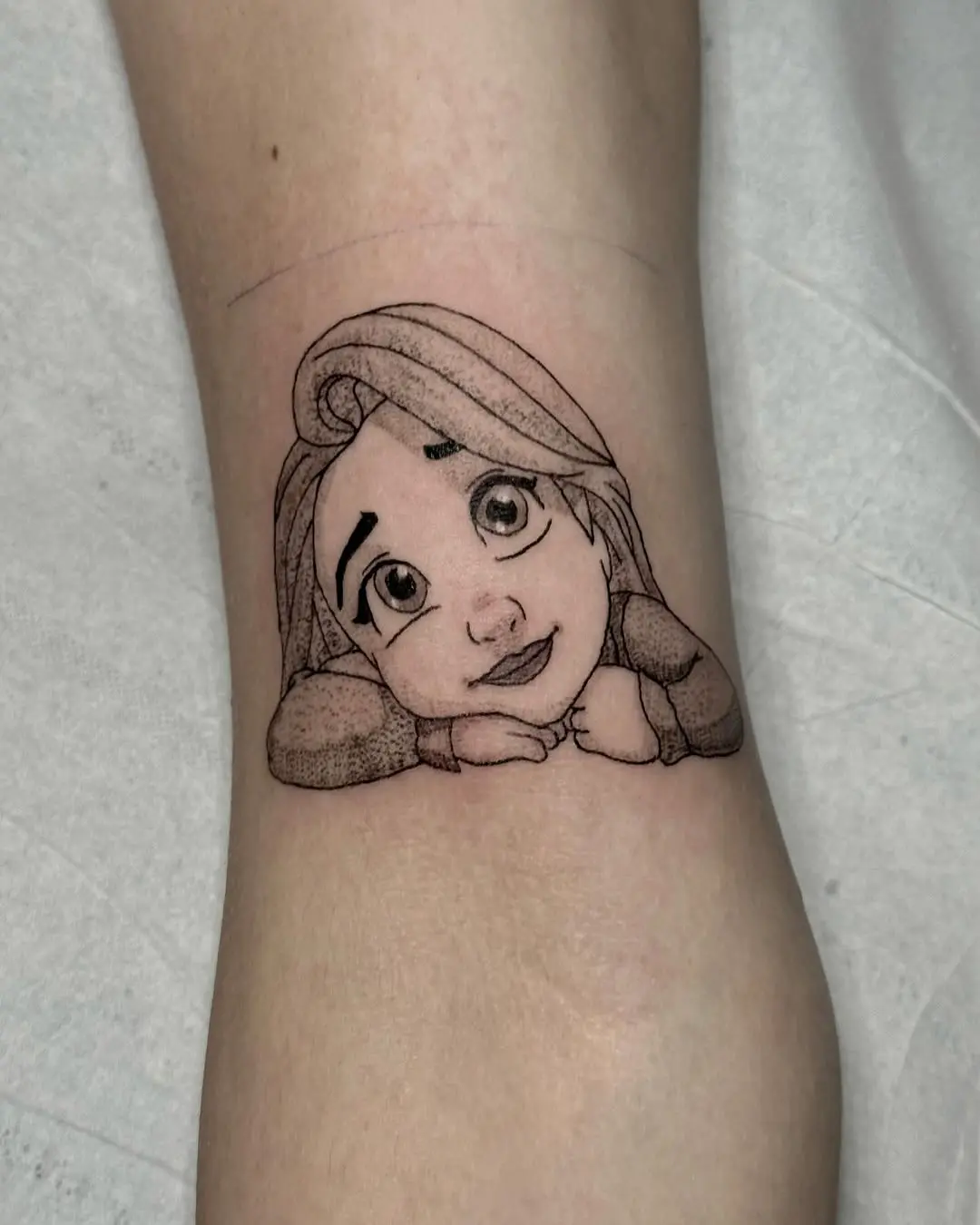 Charming Rapunzel tattoo capturing innocence and wonder