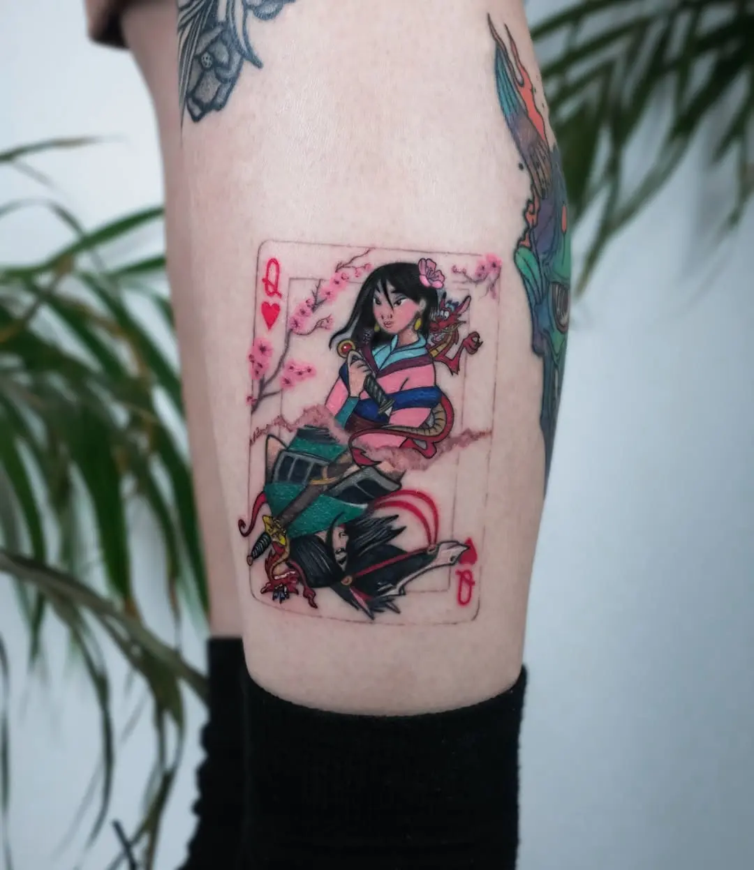 Vibrant Mulan Playing Card Tattoo Design