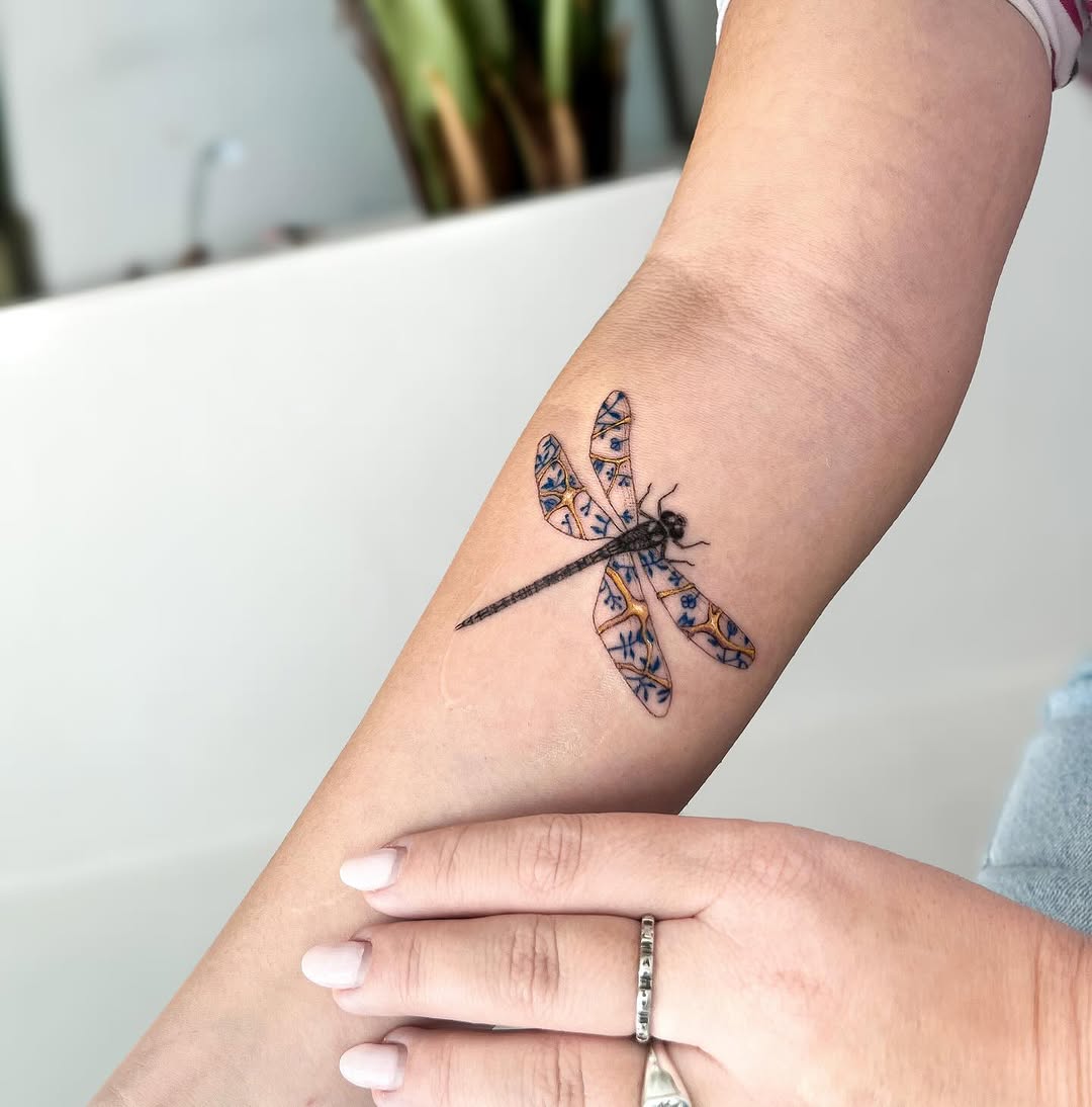 Elegant dragonfly tattoo with kintsugi artistry