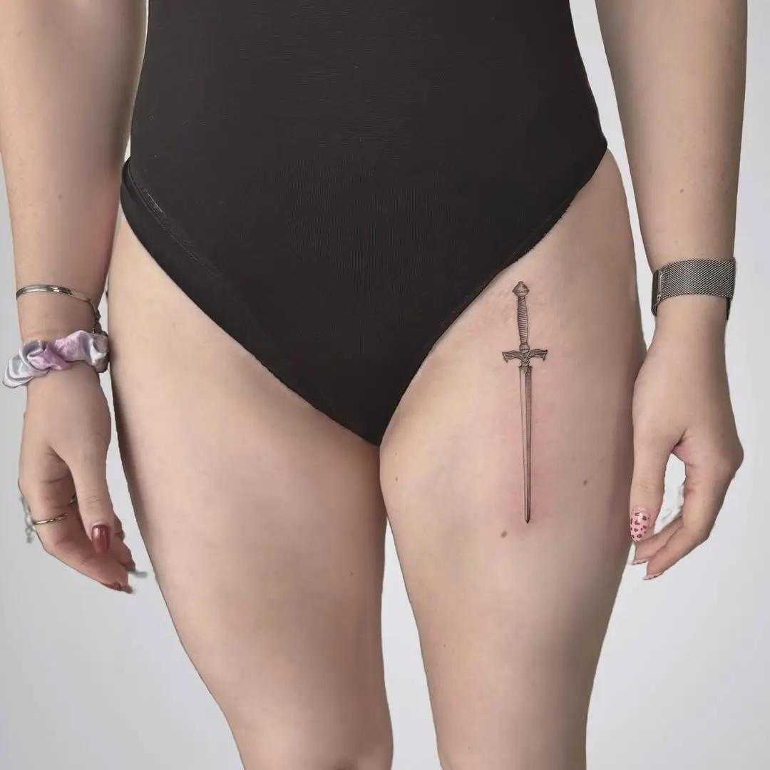 Elegant sword tattoo enhances thigh aesthetics