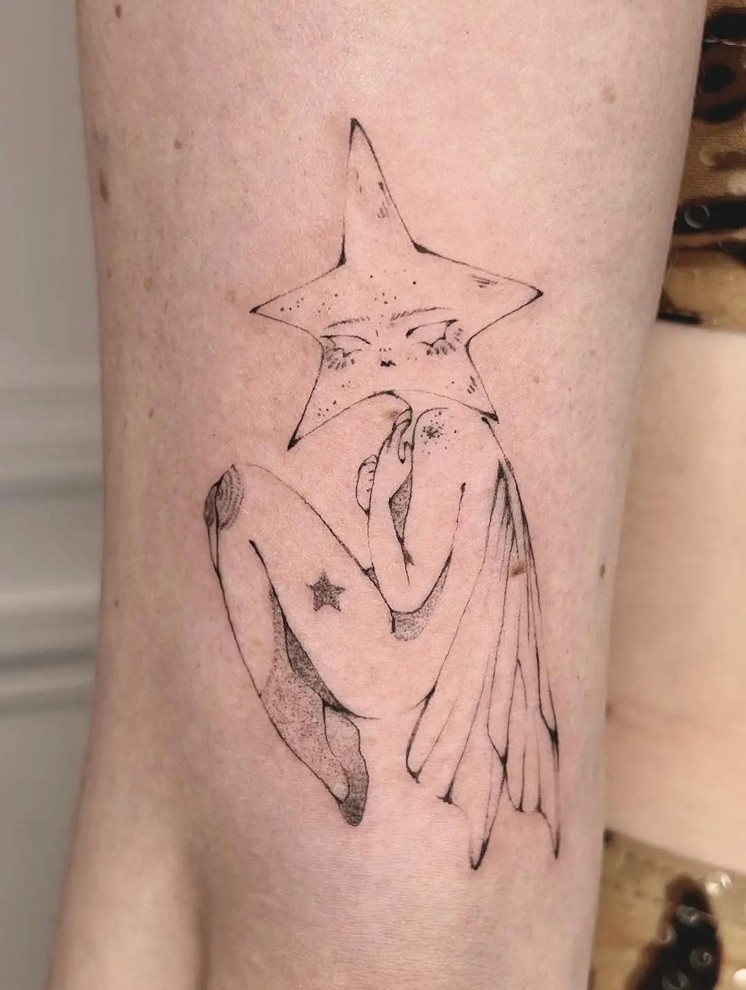 Minimalist fairy tattoo with a star theme