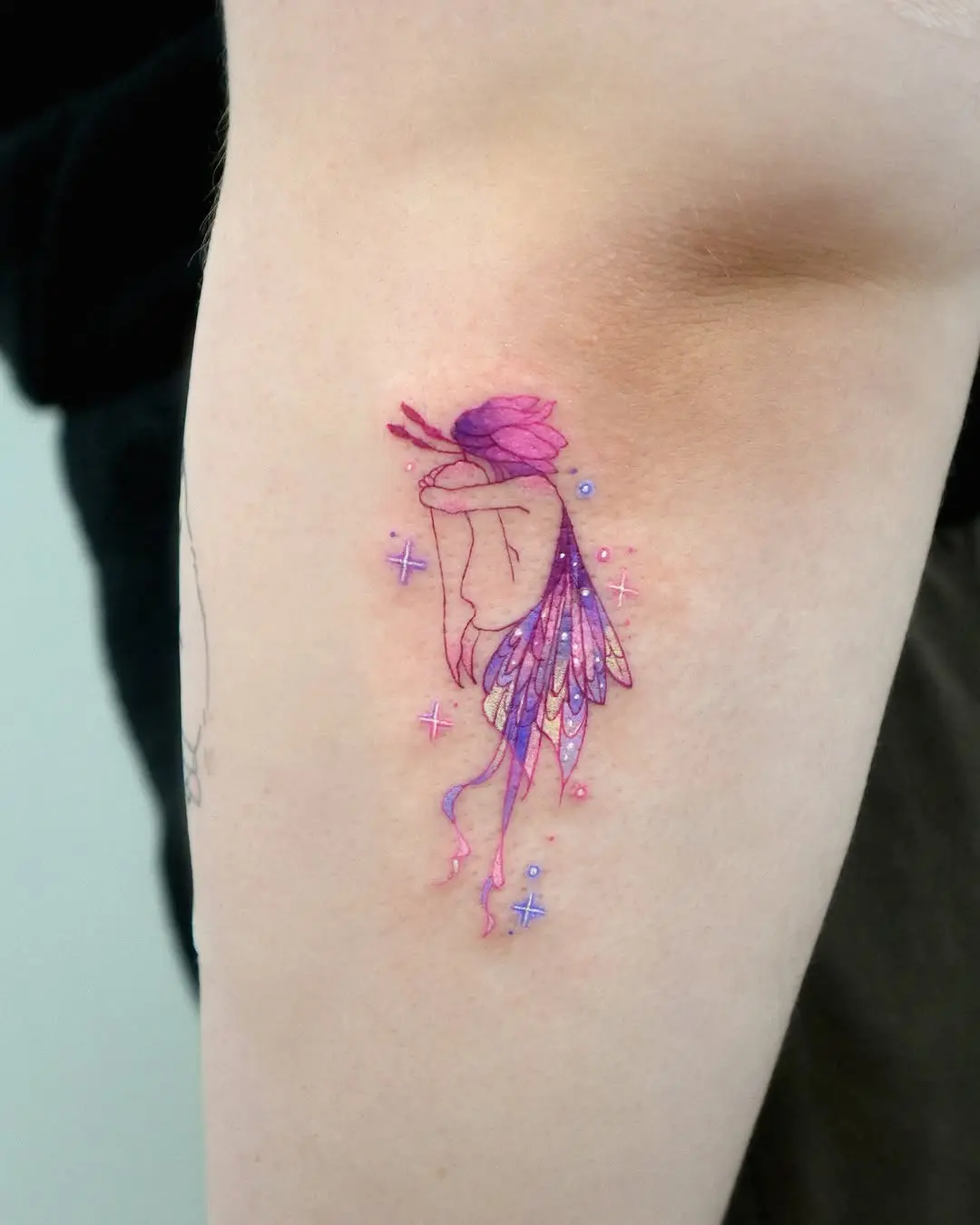 Whimsical fairy tattoo with pastel colors