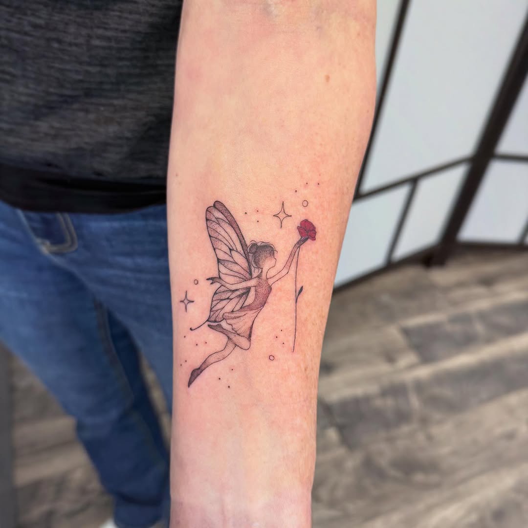 Delicate fairy tattoo reaching for a flower