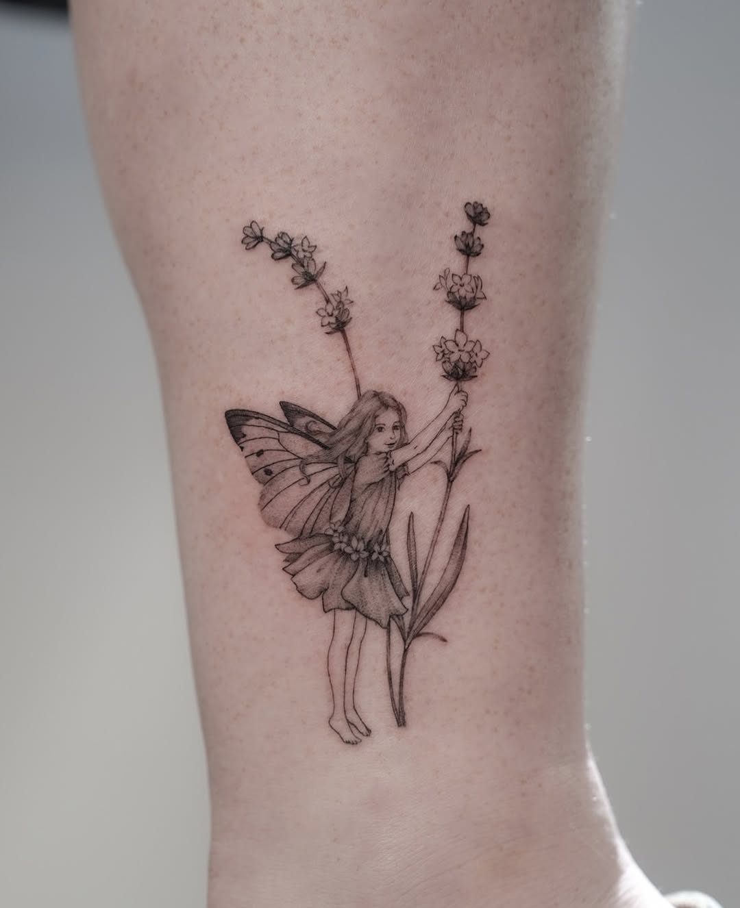 Delicate fairy surrounded by lavender flowers